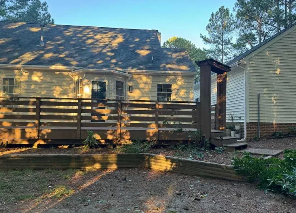 A house with a wooden fence in front of it