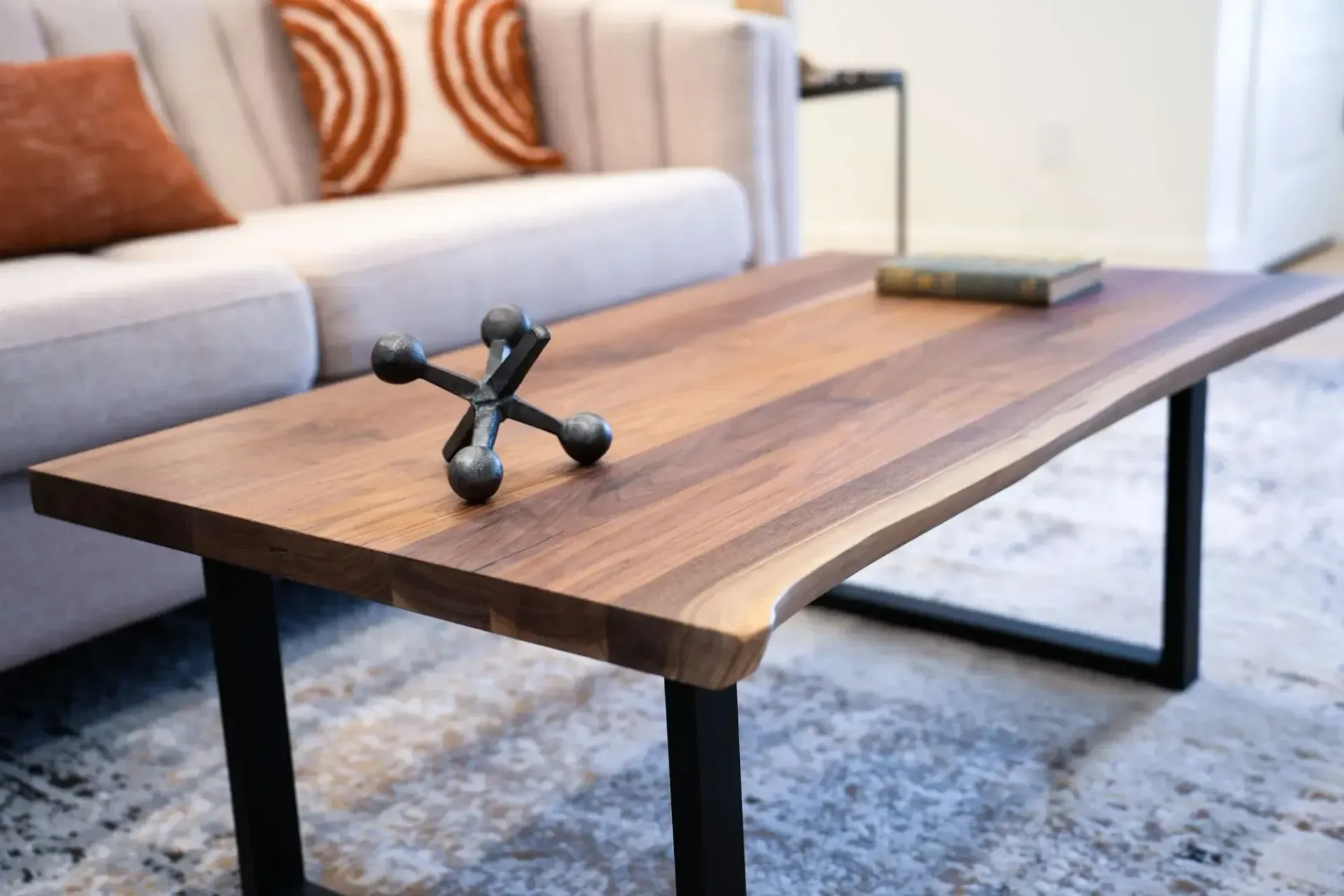 A wooden coffee table in a living room next to a couch.