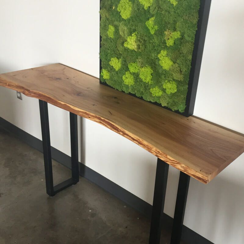 A wooden table with a picture of moss on it