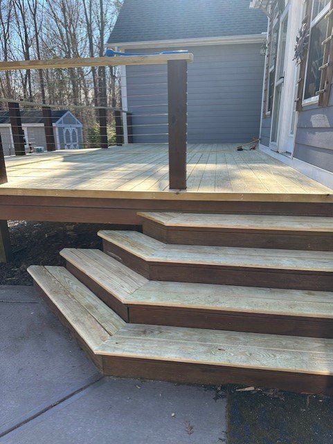 A wooden deck with stairs leading up to it.