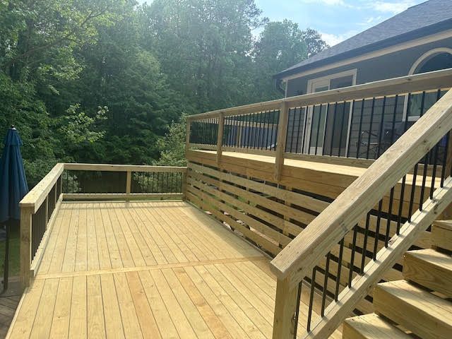 A wooden deck with stairs leading up to it