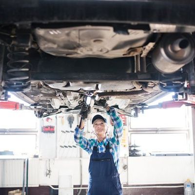 Brake Repair — Woman Repairing Car  in Medford, OR