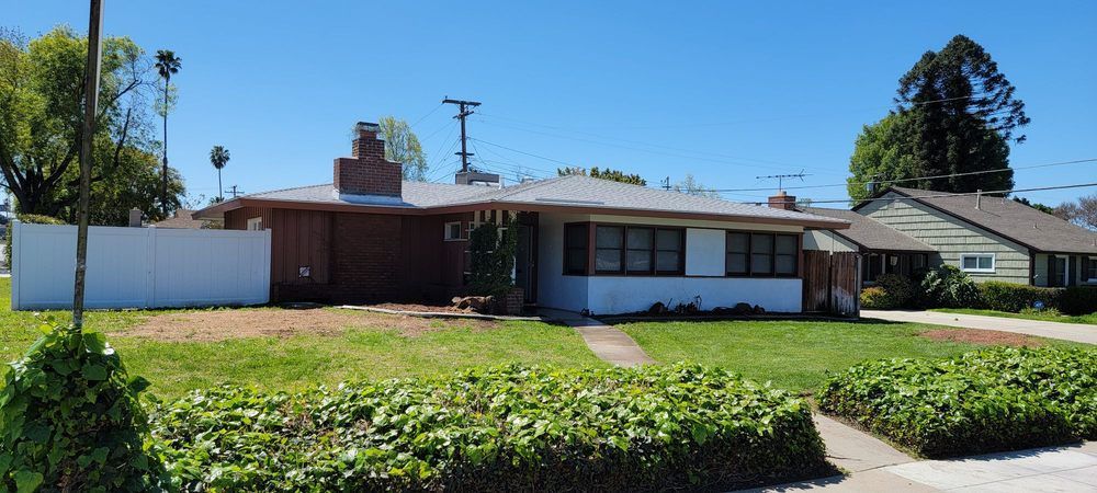 A house with a white fence in front of it