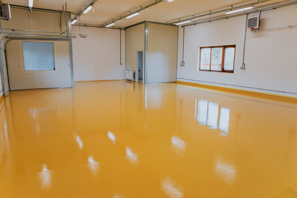 Empty industrial space with glossy yellow floor and white walls.