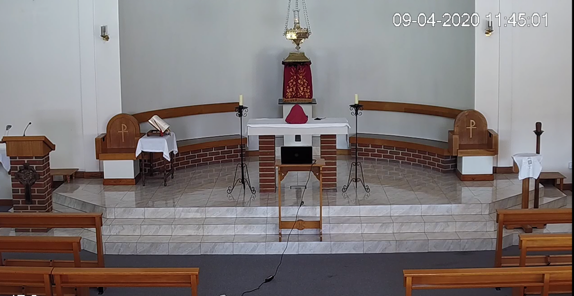The inside of a church with a podium and altar.