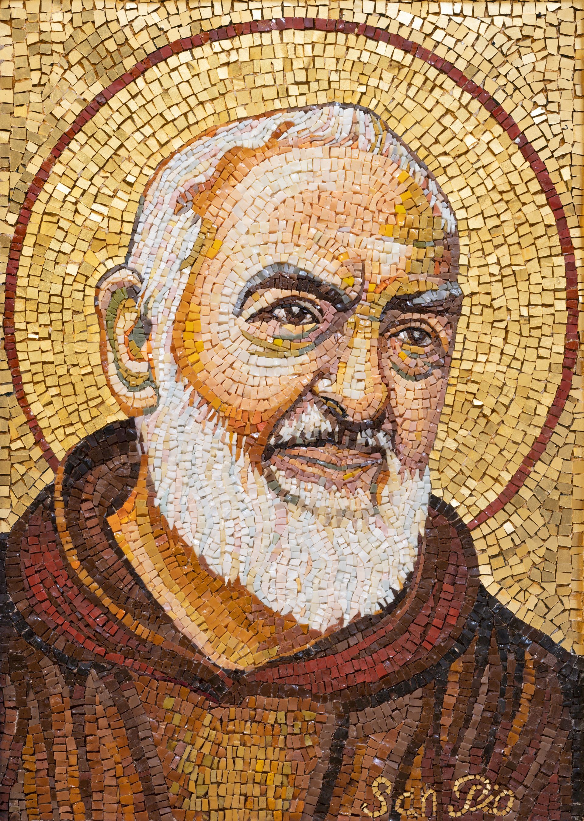 A mosaic portrait of Padre Pio with a beard and a halo around his head.