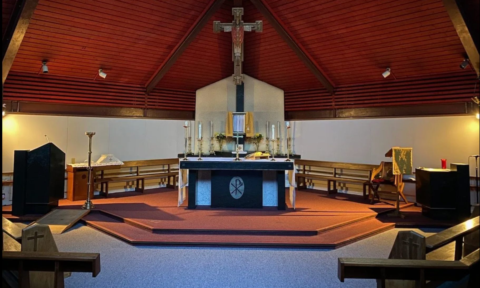 The inside of a church with a cross on the altar