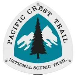 Pacific Crest Trail marker: Teal, white, and black design with text, a fir tree, and mountains.