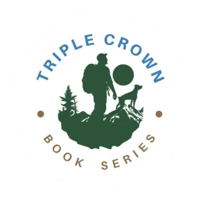 Hiker with backpack and walking stick, accompanied by a dog wearing a pack, hiking outdoors.