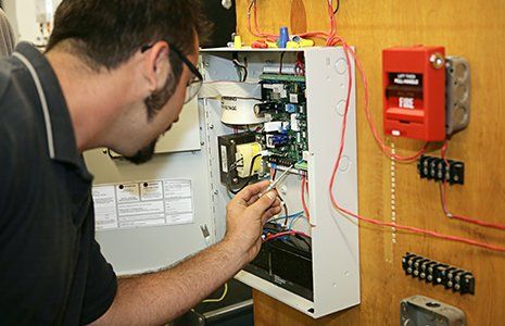 Worker Repairing Fire Alarm — Great Bend, KS — Pryor Automatic Fire Sprinkler