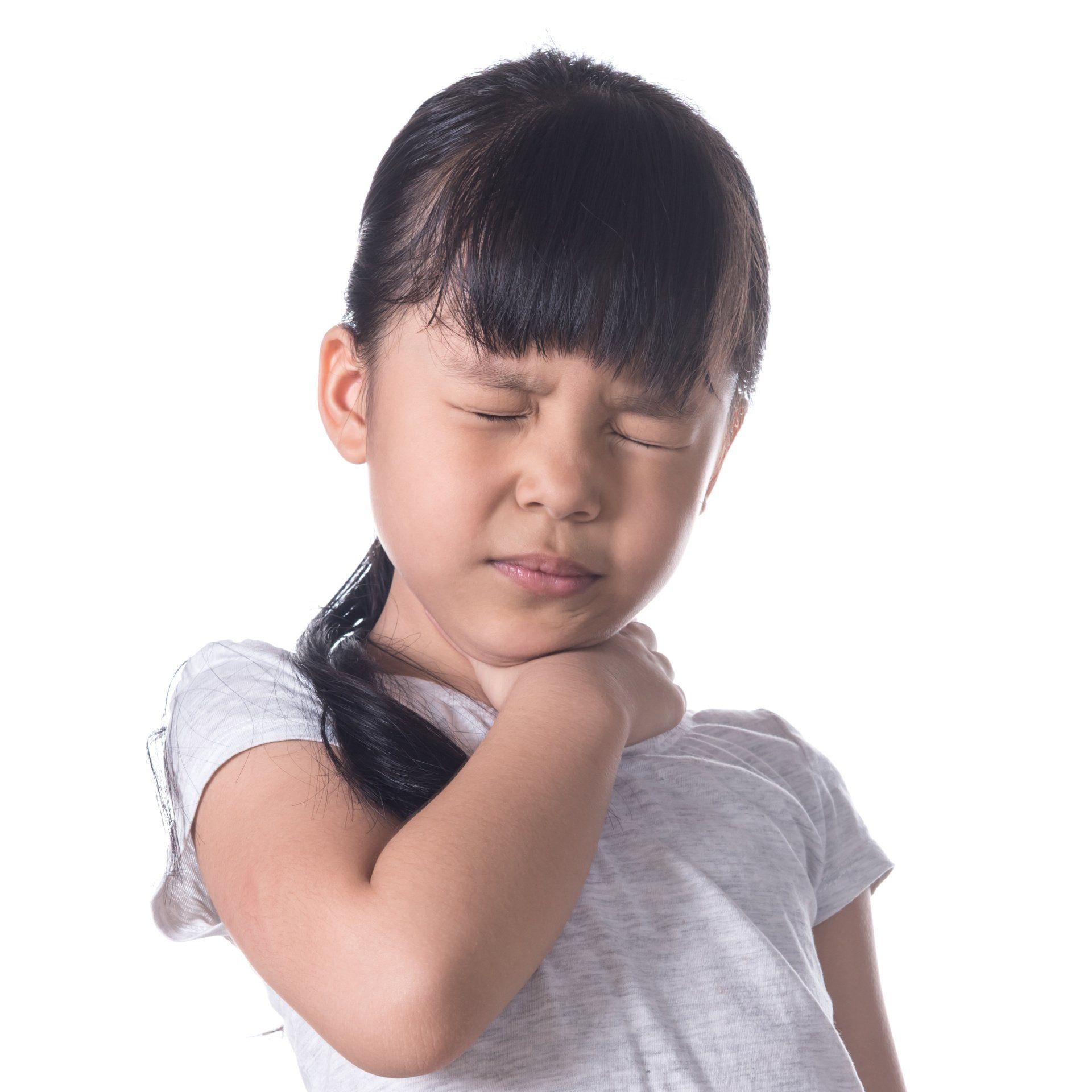 a little girl is holding her neck because she has a sore neck .