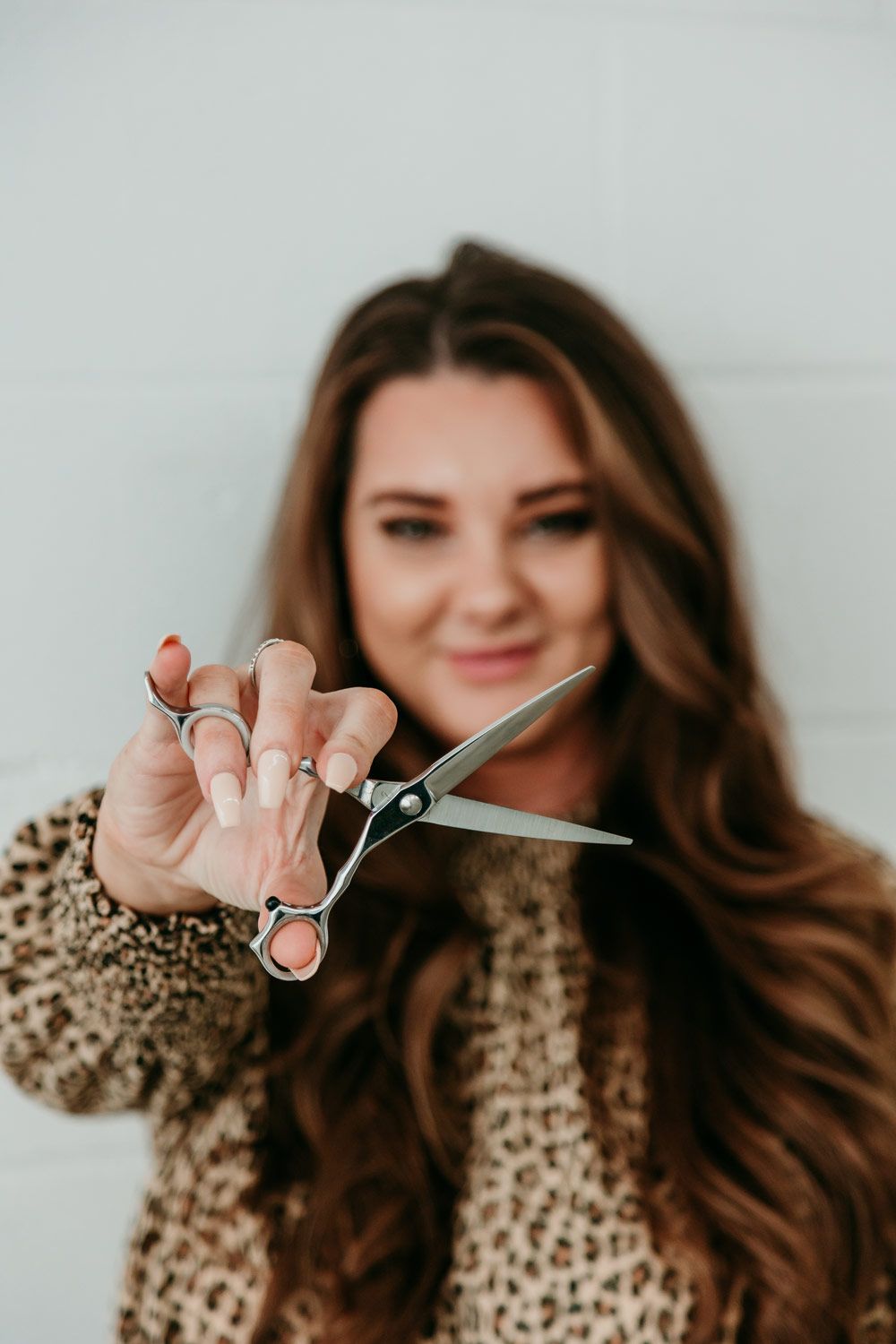 Woman Holding Hairdresser Scissors — Gladstone Beauty Clinic In Gladstone Central QLD