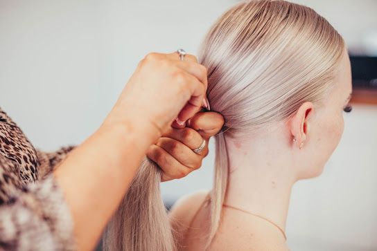 Beautiful Woman Having Her Hair Cut At The Hairdresser's — Gladstone Beauty Clinic In Gladstone Central QLD