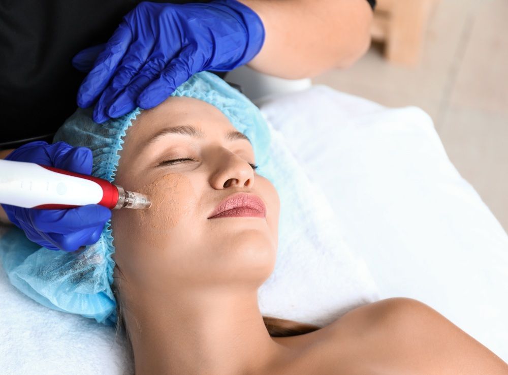 Woman is Getting a Facial Treatment in a Beauty Salon — Gladstone Beauty Clinic In Gladstone Central, QLD