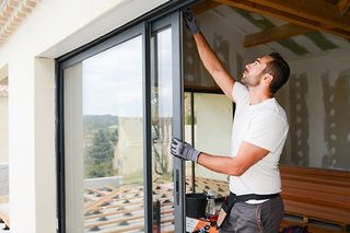 Glass Service — Man Installing Glass Door in House in Pleasanton, CA