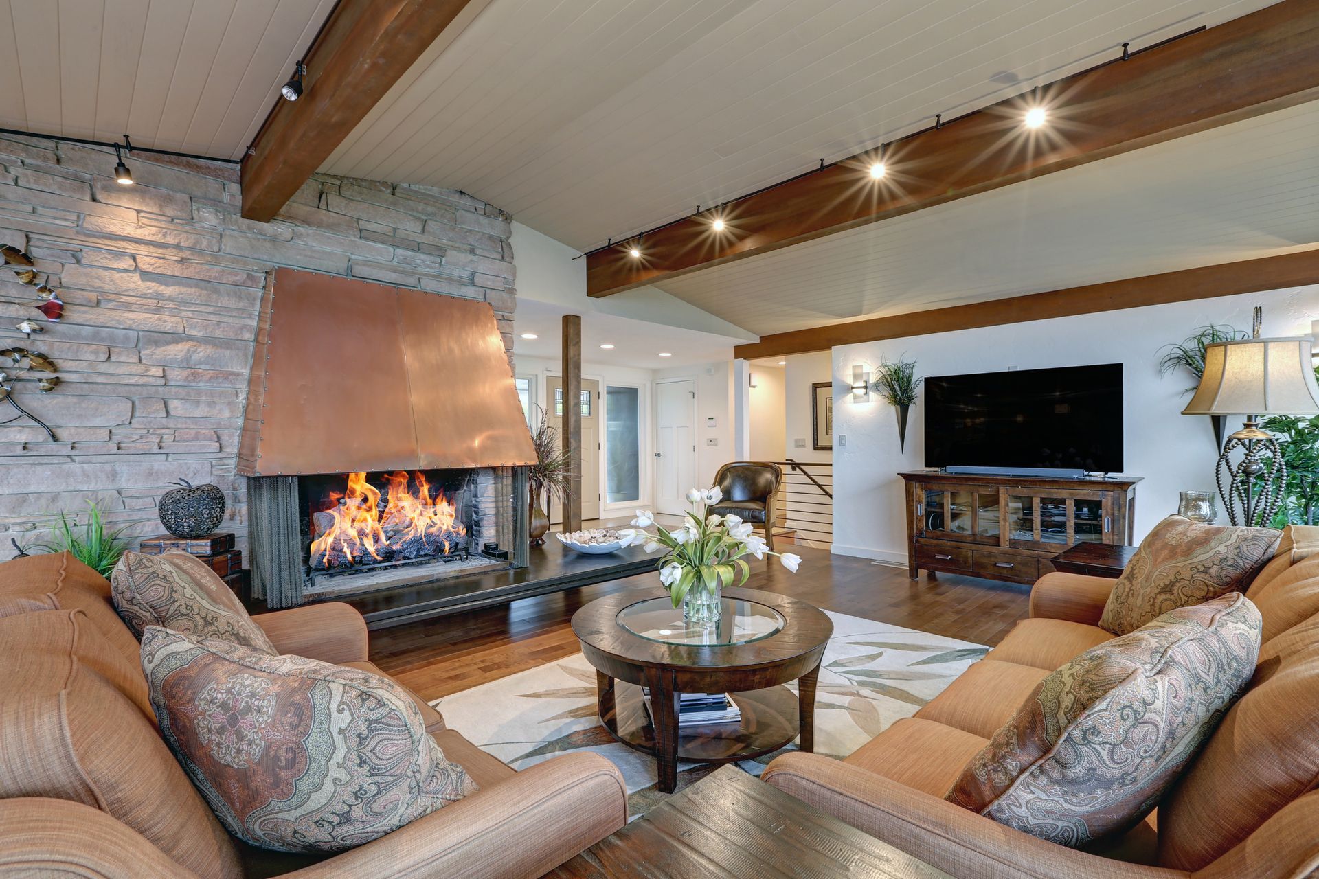 A red house in the snow with a mountain in the background