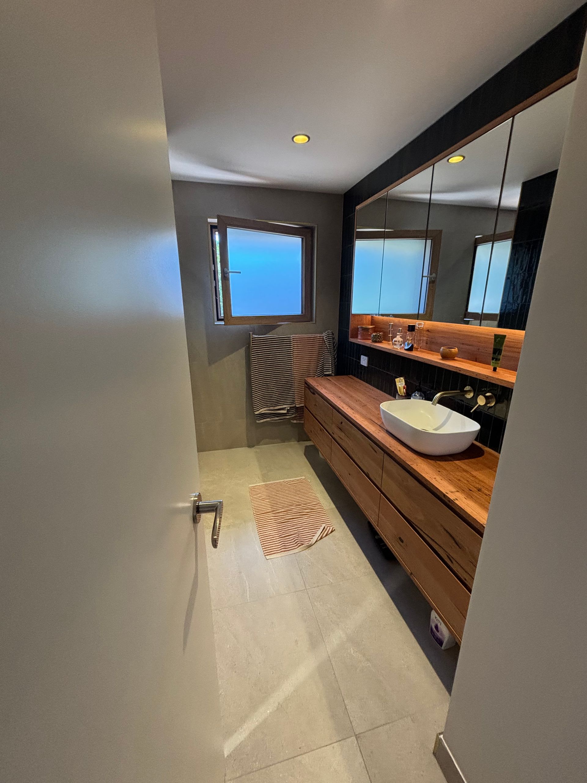 A kitchen with a large island and stools