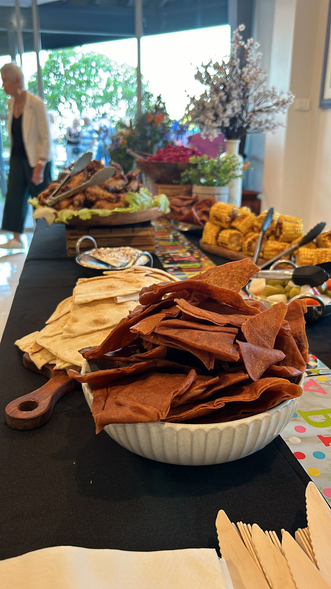 Buffet table with various food items: meats, bread, crackers, and condiments. — The Habibiz Catering In Wingham, NSW