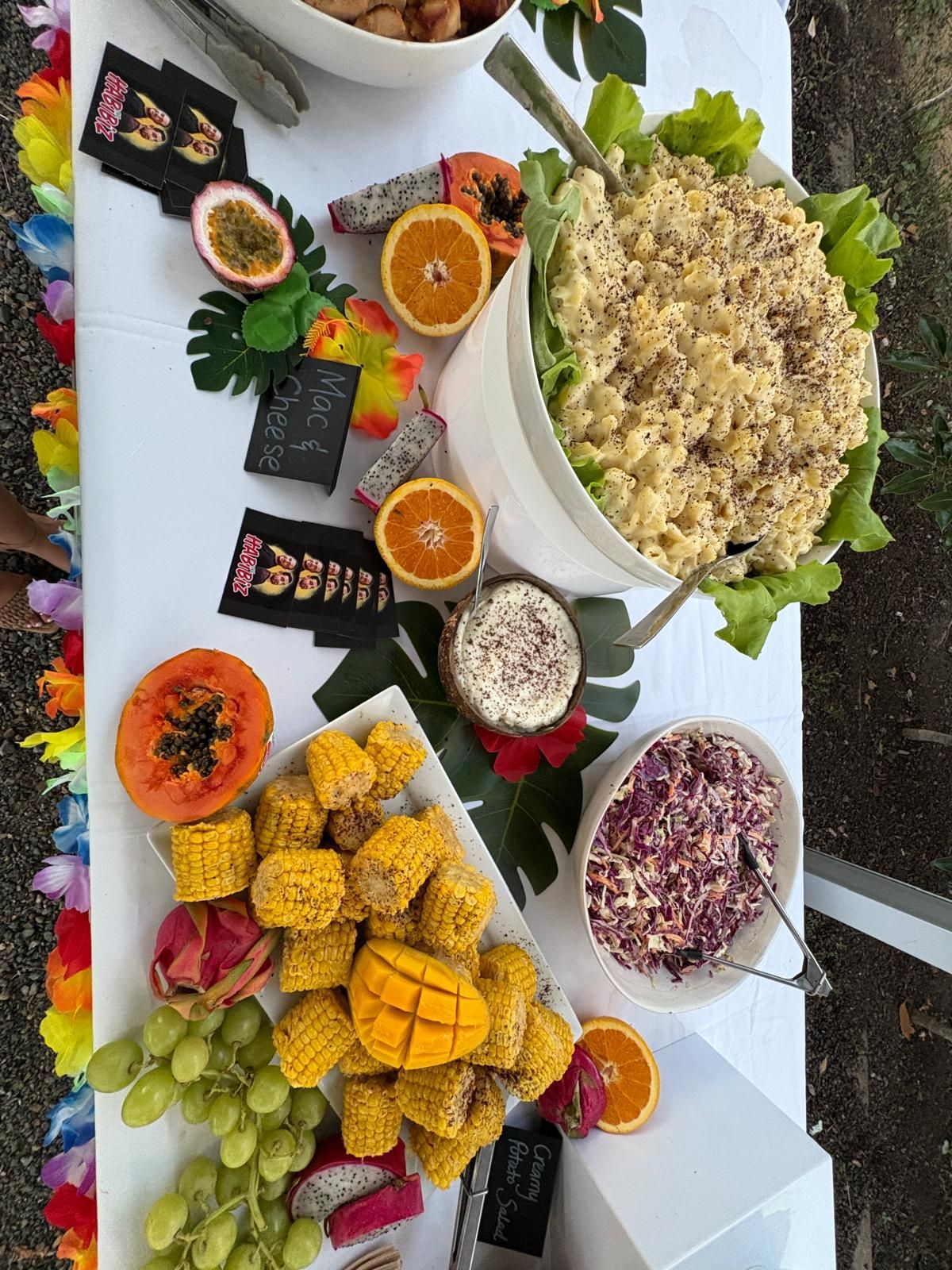 Tropical buffet table with fruits, salads, and corn. — The Habibiz Catering In Wingham, NSW