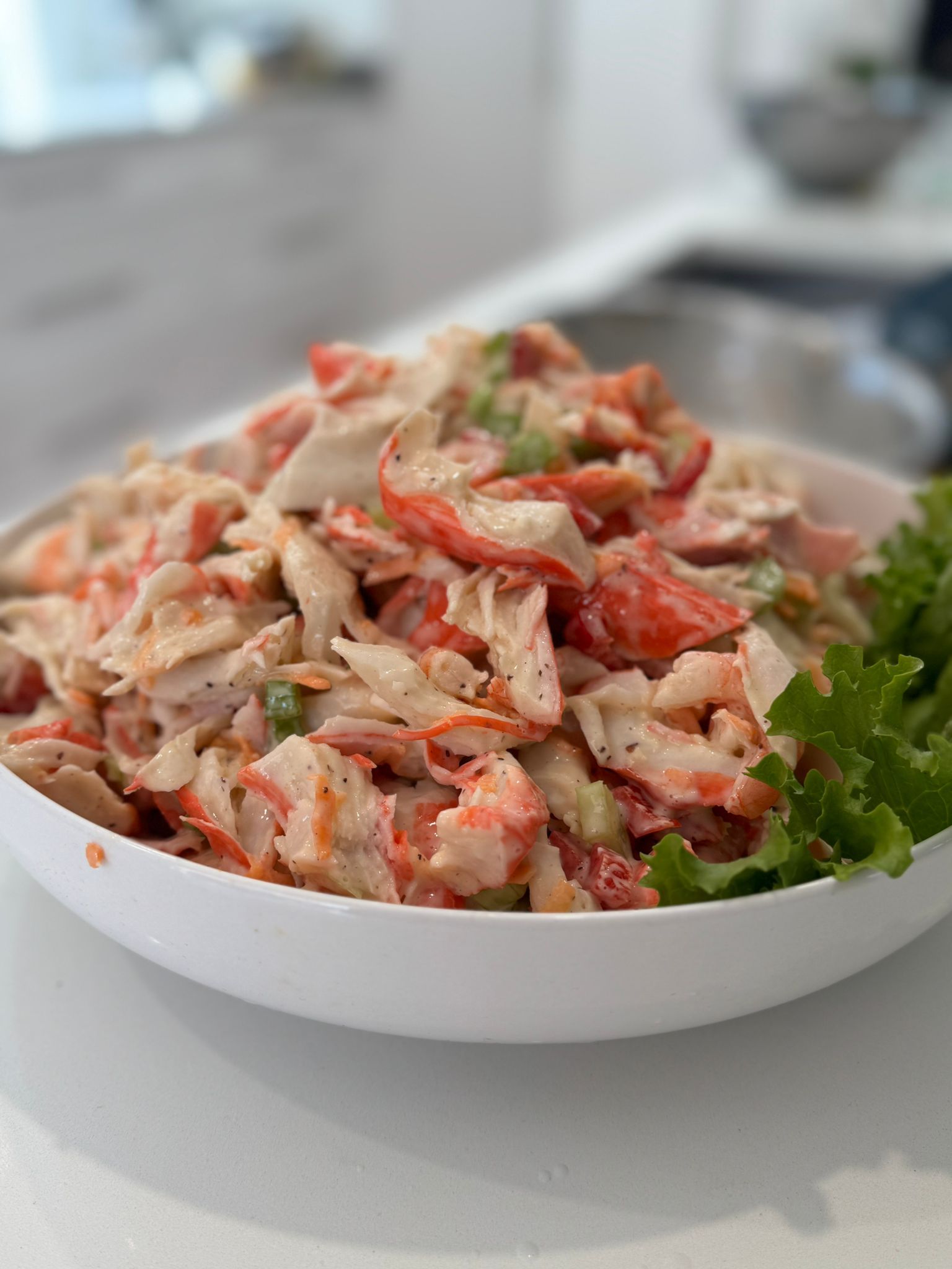 Crab salad in white bowl with lettuce, on a white countertop. — The Habibiz Catering In Wingham, NSW