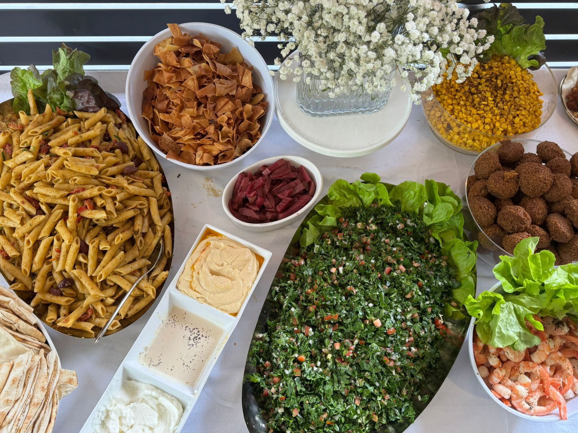 Buffet of Middle Eastern food, including pasta, falafel, hummus, and tabbouleh. - The Habibiz Catering in Wingham NSW
