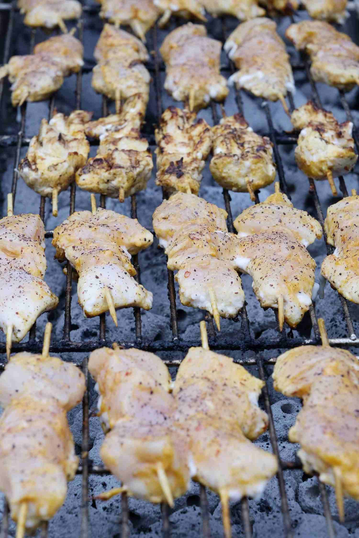 Chicken Skewers on A Grill, Some Cooking and Browning, Others Raw — The Habibiz Catering In Wingham, NSW