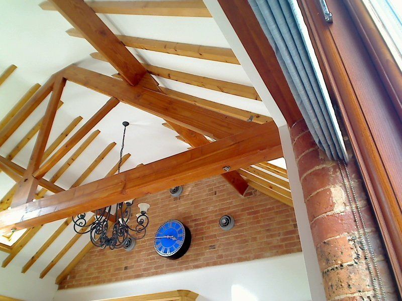 King post trusses, warm roof detail with exposed rafters.
