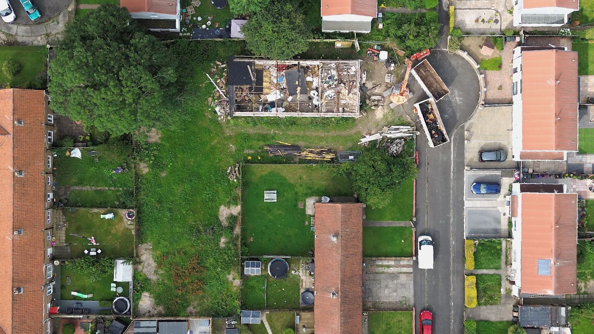 Ariel view of the site whilst the demolition of the building takes place with an excavator.