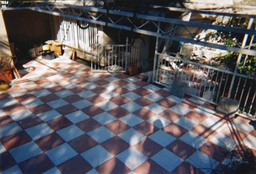 un pavimento di un balcone a piastrelle a quadri bianchi e rossi