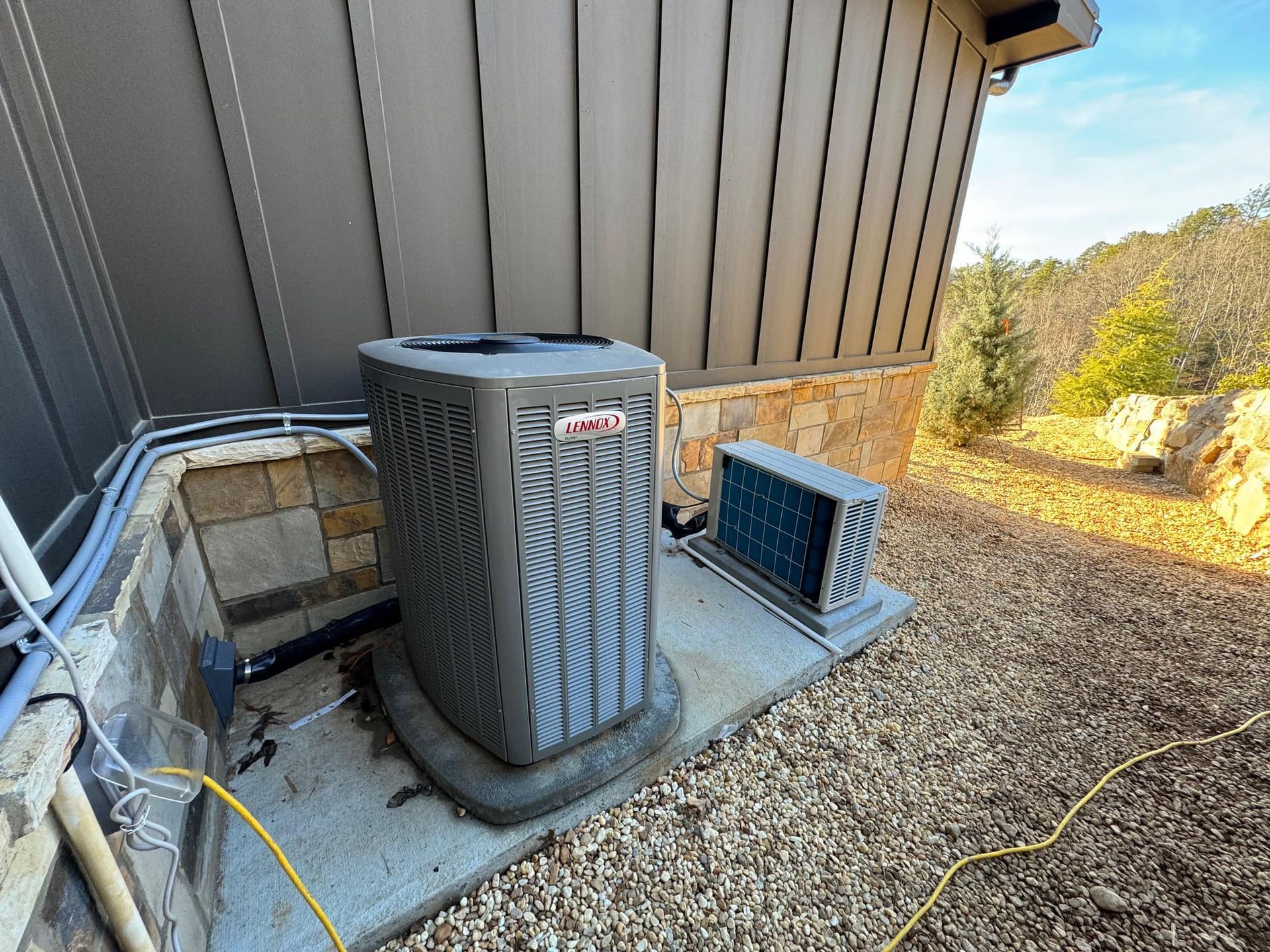 A large air conditioner is sitting on the side of a building.