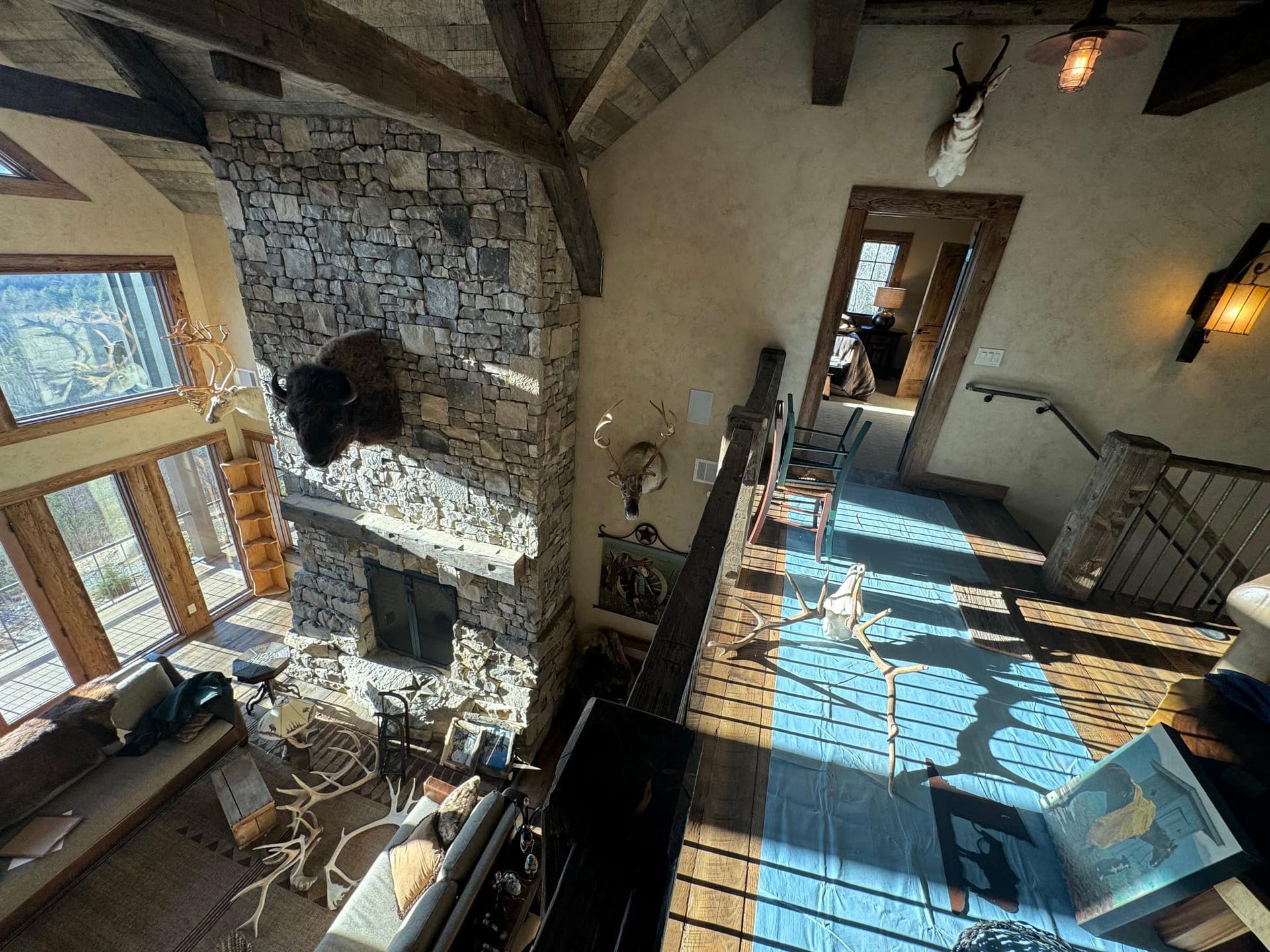 An aerial view of a living room with a fireplace and stairs.