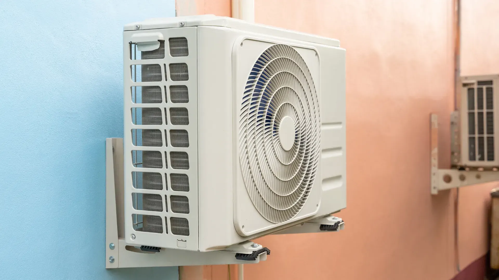 A white air conditioner is mounted on a wall.