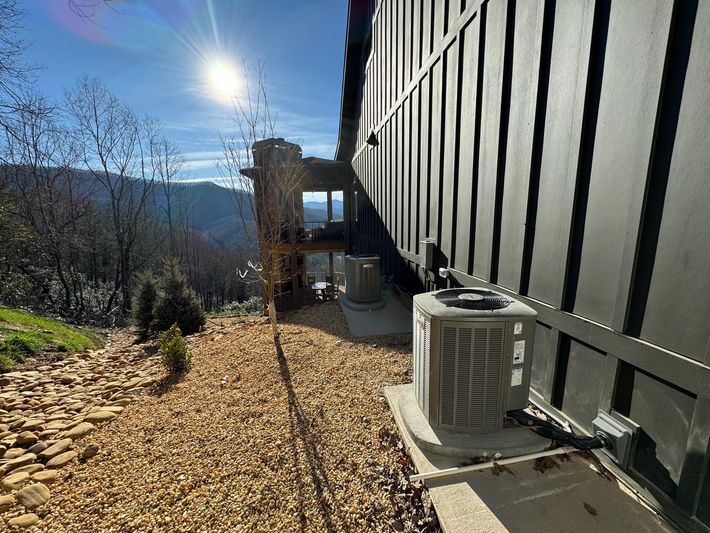 A house with a large air conditioner on the side of it.