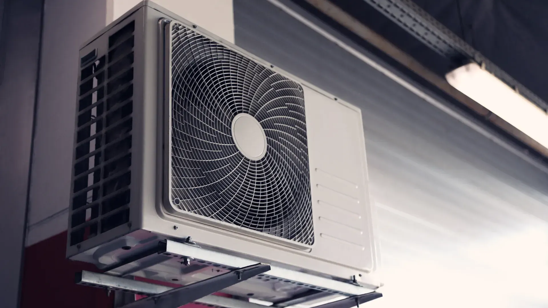 A fan is hanging from the ceiling of a building.