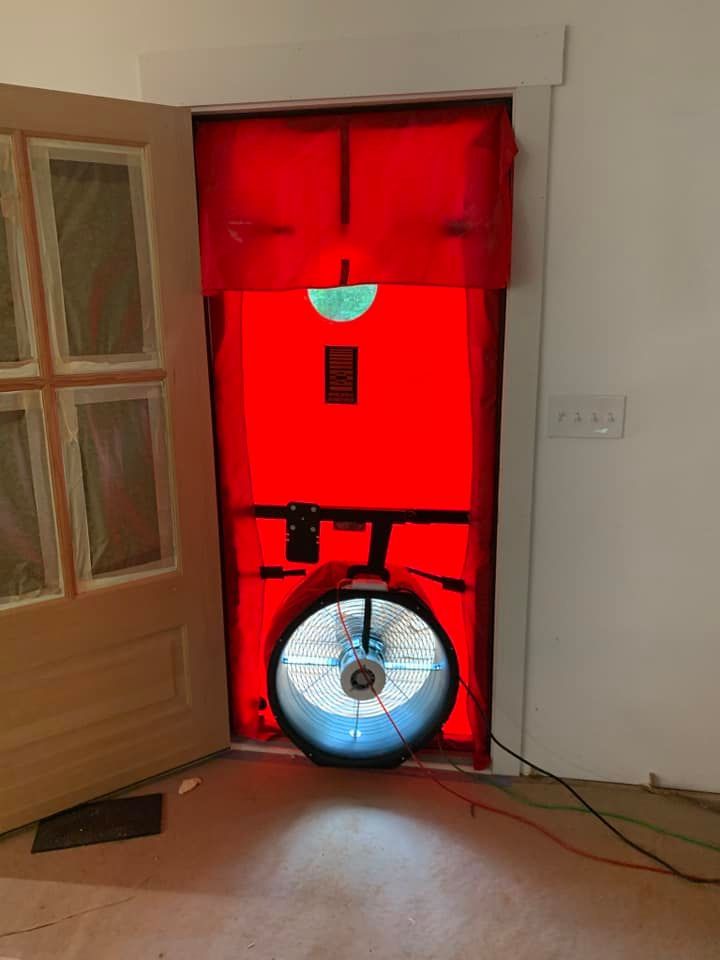 A red door with a fan coming out of it.