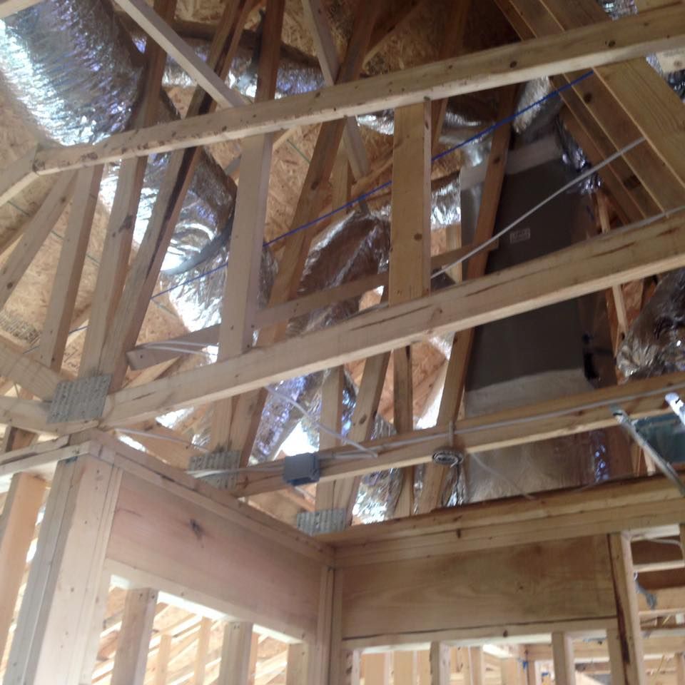 The ceiling of a house under construction with a lot of wooden beams