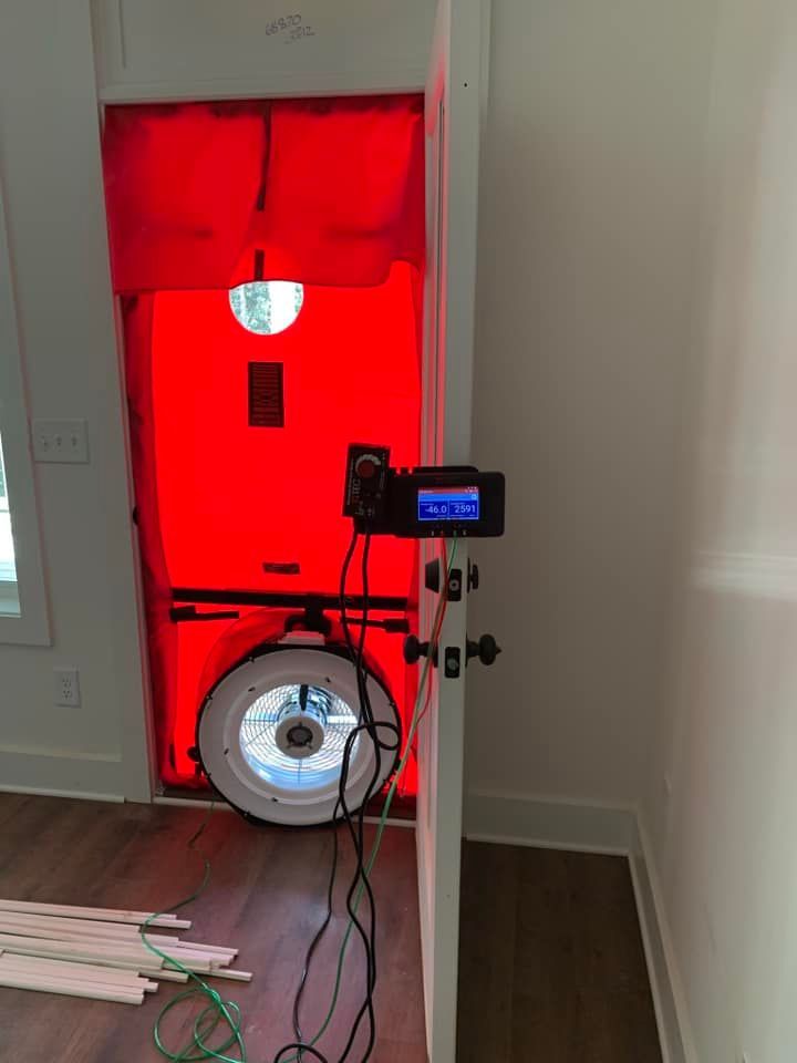 A room with a red door and a fan in it.