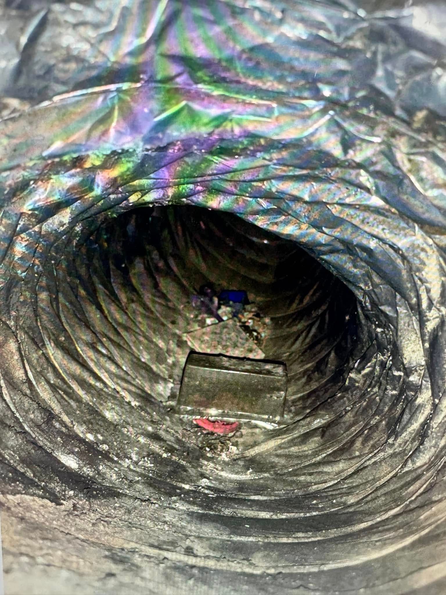A close up of a duct with a hole in it.