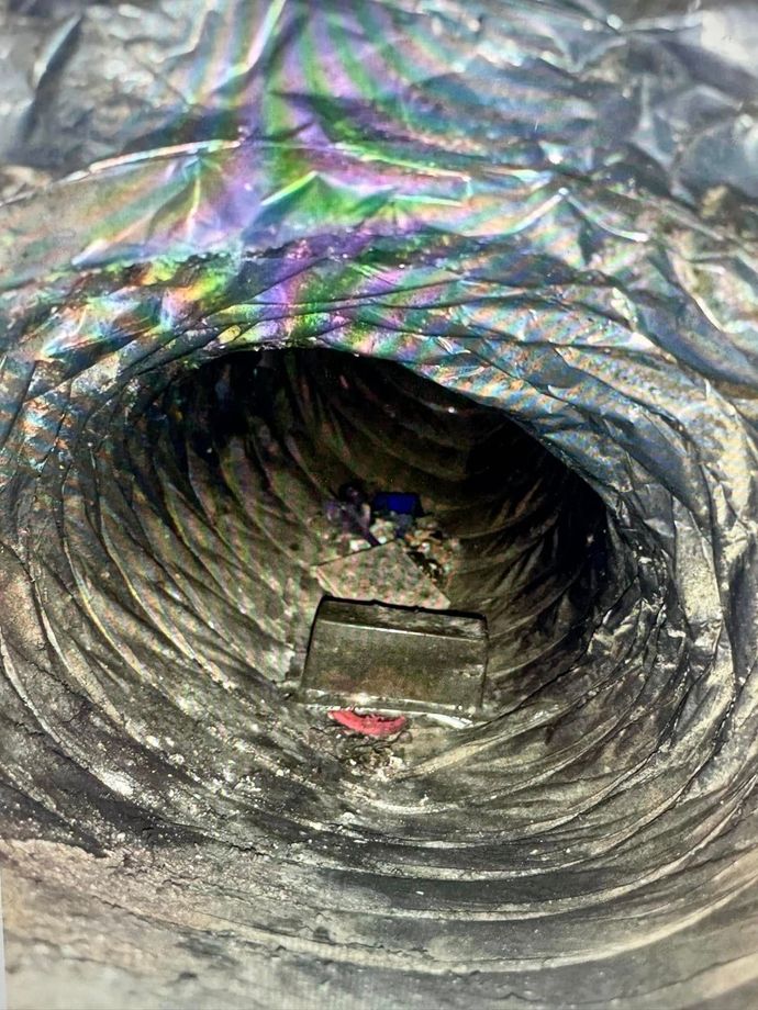 A close up of a duct with a hole in it.