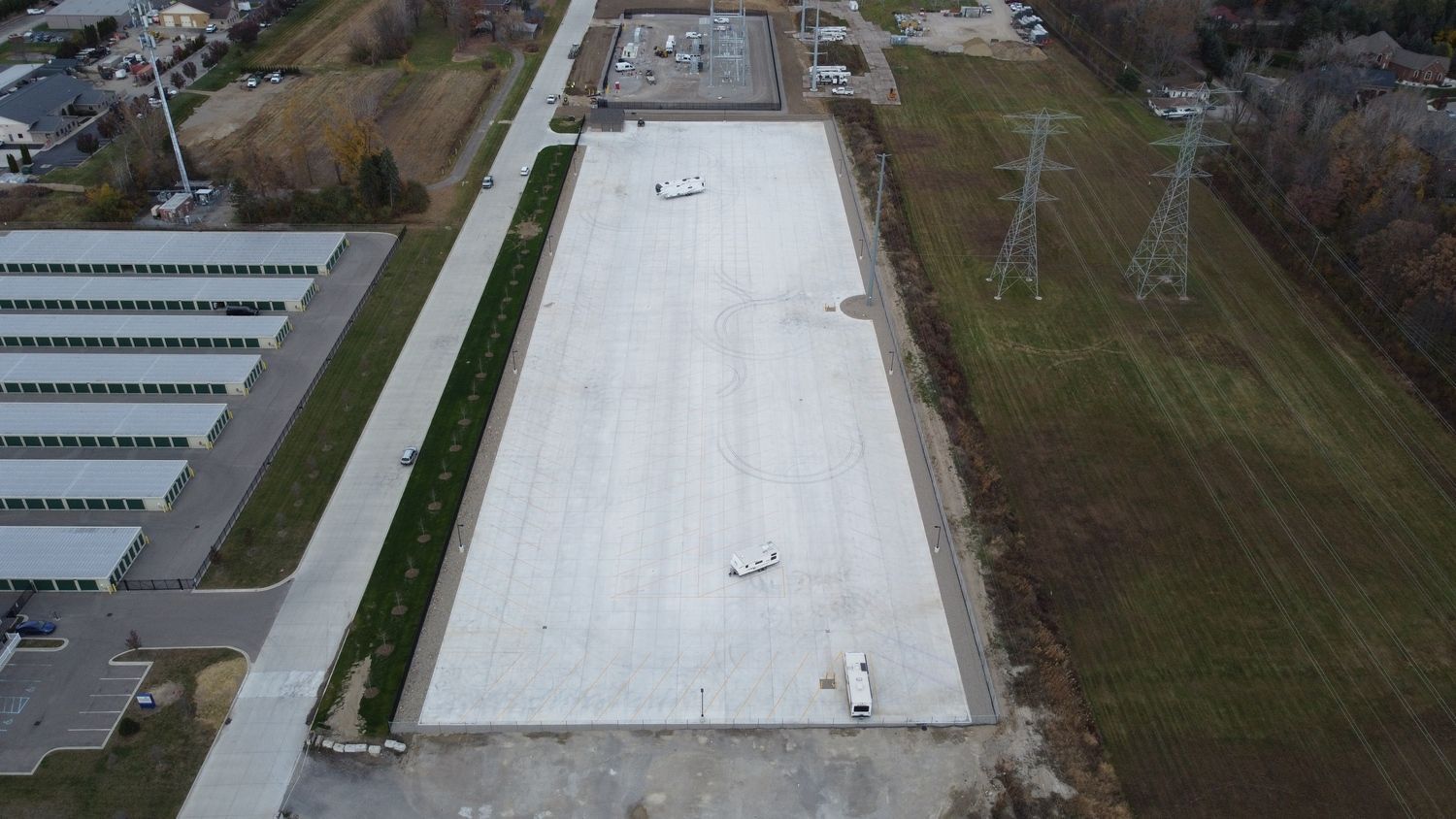 An aerial view of a large concrete parking lot for storing RV's, boats, etc.