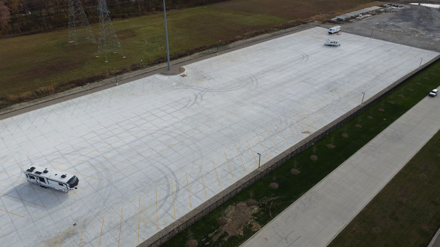 An aerial view of a parking lot with RV's parked in it.