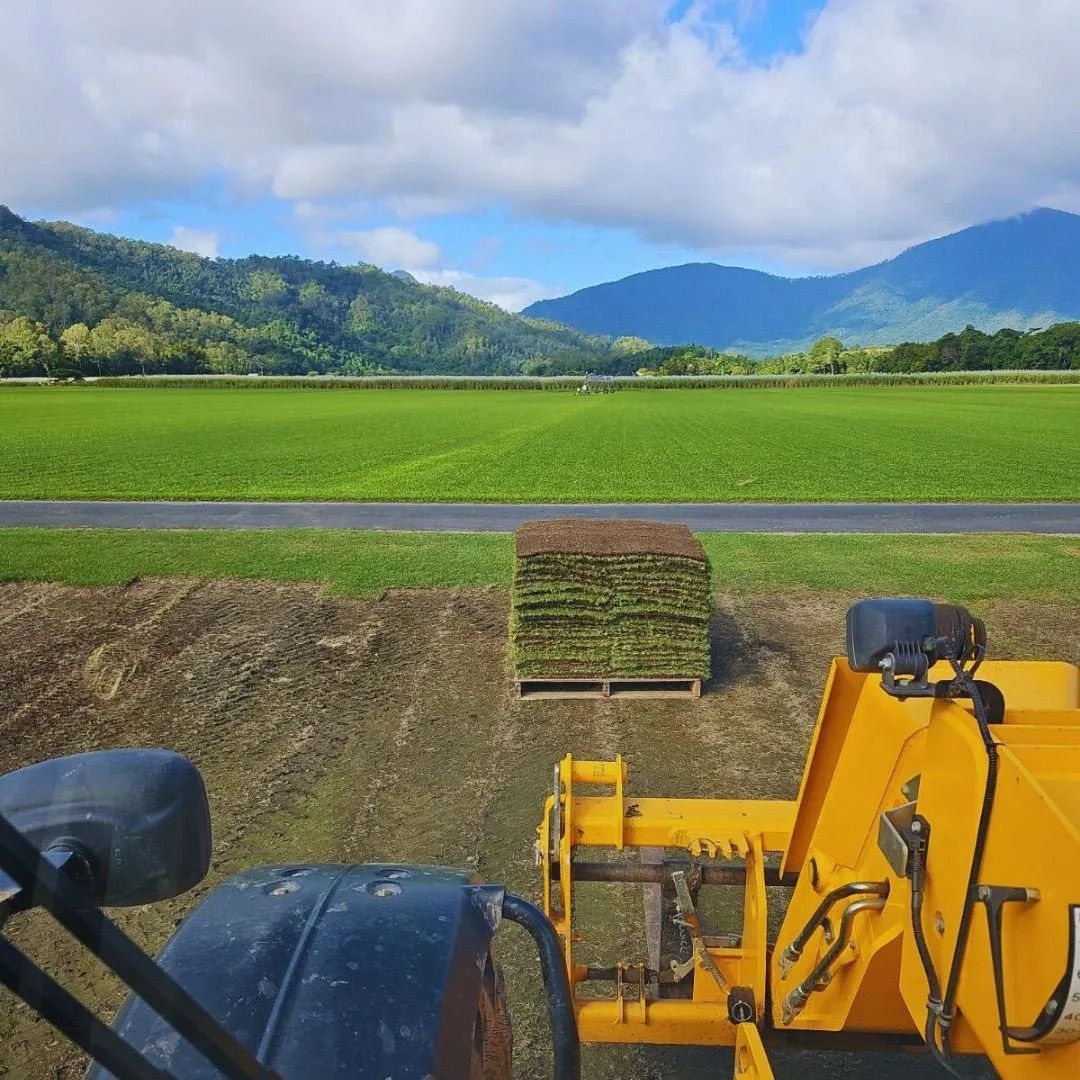 Yellow Tractor In Lawn Surface For New Turf