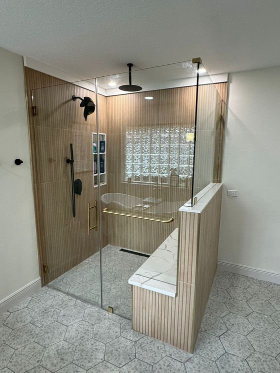 A bathroom with a walk in shower and a bathtub.