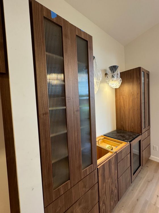 A kitchen with wooden cabinets and a sink.