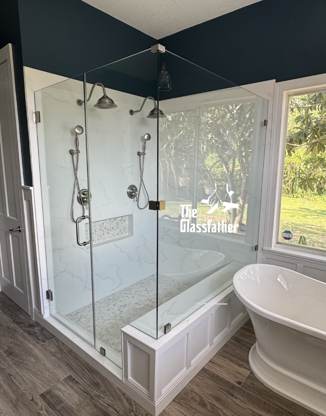 A bathroom with a tub and a shower with a glass door.