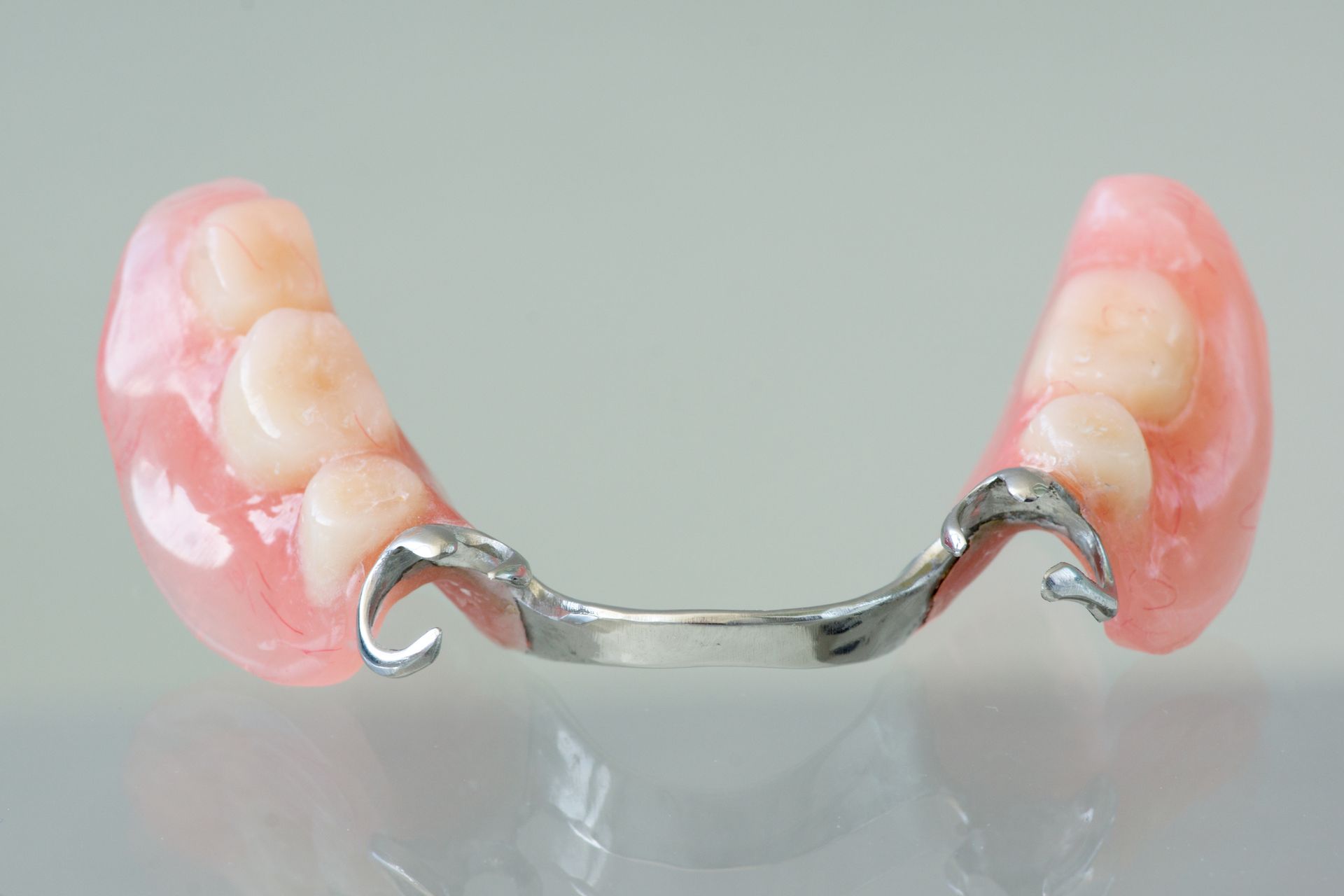 Partial denture with pink gums and artificial teeth.