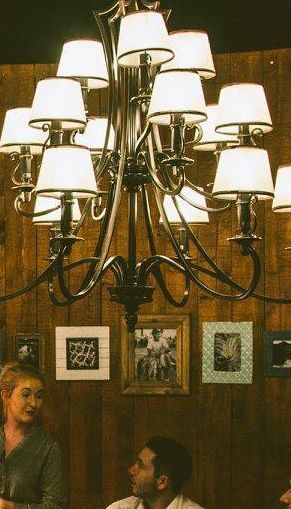 a man and a boy are sitting at a table in a restaurant .