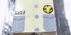 Cake decorated to look like a cream-colored uniform with buttons, pockets, and patches, one that says 