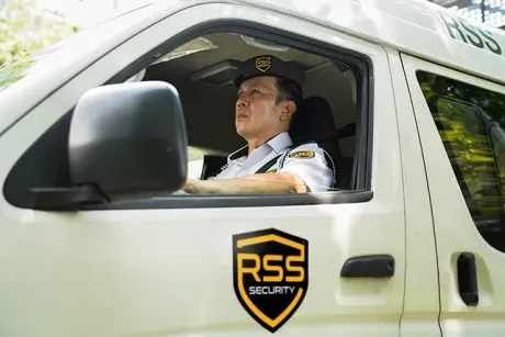 A security guard in a white van with 