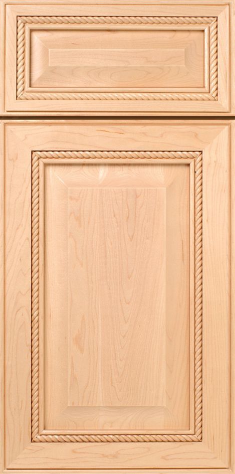 Light wood kitchen cabinet door with rope-style edging detail.